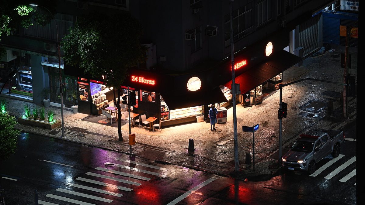 Esquina com asfalto molhado pela chuva durante a madrugada, no Rio de Janeiro