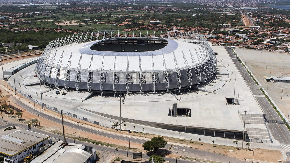 Arena Castelão vista do alto, com a cobertura branca e o estacionamento, em Fortaleza