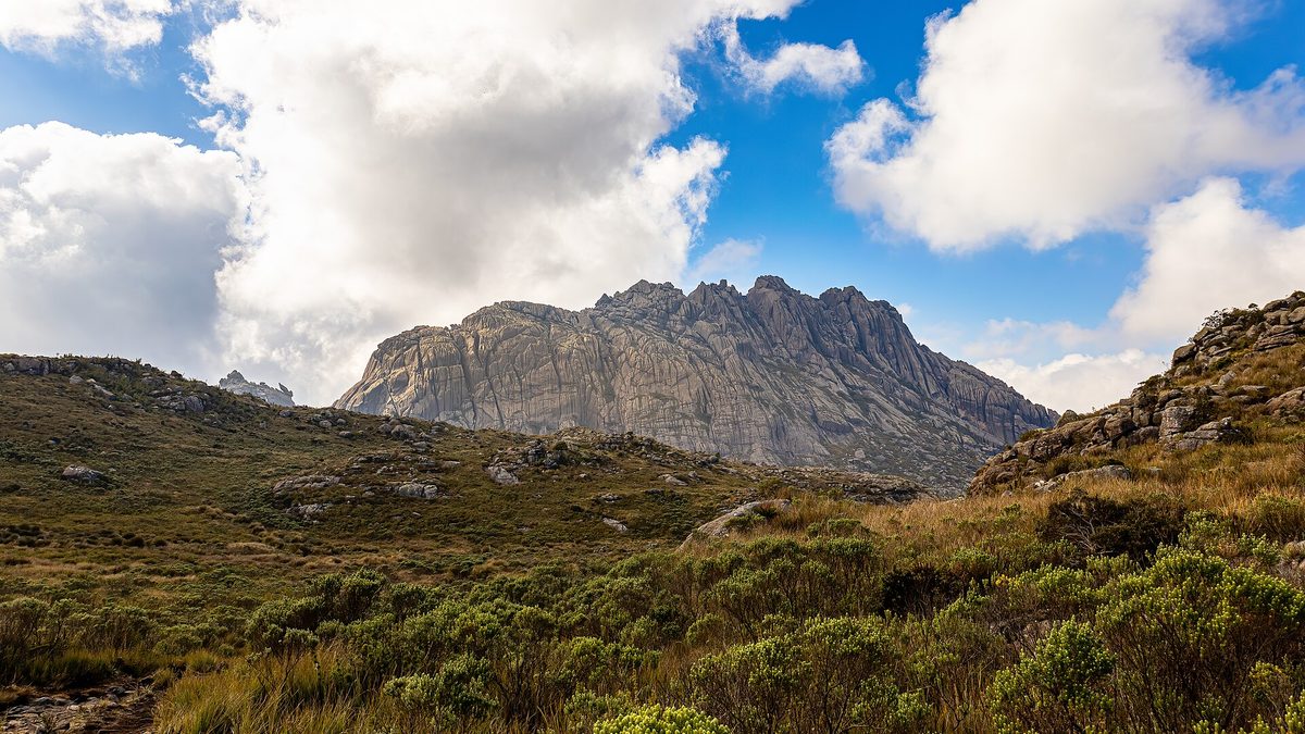Maciço rochoso das Agulhas Negras ao fundo de campos de altitude no Parque Nacional do Itatiaia
